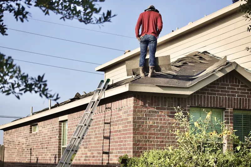 Professional roofer working on a residential roof in Rocky Nook